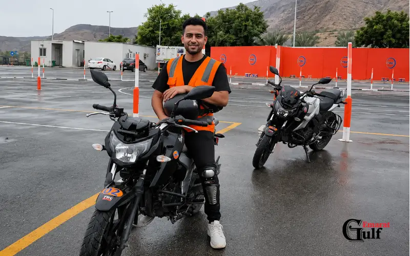 Jebel Ali Police Station public safety awareness training with a motorcycle officer practicing road safety procedures in a professional training area.